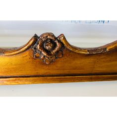 an antique wooden bed frame with carved details