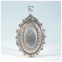 A silver locket, an icon of the Victorian Era. It can be worn on a collar for a dressy look that rivals any diamond dribbles, it can be worn on a chain or even a black ribbon with jeans and a flip flops or over a turtle neck to great effect. It's an essential that's far from basic. This wonderful locket was hand crafted in about 1880, it has panache, style that is. It was most likely made in the English jewelry center of Birmingham, but it has no marks, we've carefully tested it to verify that it is, indeed, sterling silver. The locket has a wonderful sunburst with geometric details repoussed in the front and a soft and smooth rounded oval back. This locket opens to reveal two frames ready to hold your personal photos. The locket measures 55 mm north to south including the bale and 33.8 mm Opal Solitaire Ring, English Jewelry, Silver Locket, A Turtle, Silver Lockets, Love To Shop, Diamond Cluster Ring, Black Ribbon, Diamond Cluster