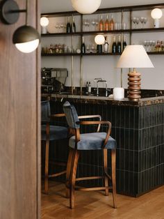 two chairs are in front of the bar