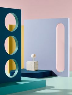 a room with different shapes and colors on the walls, including an object that looks like a cube