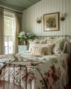 a bed sitting in a bedroom under a window next to a dresser with drawers on it