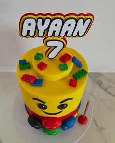 a birthday cake with legos on top and the name avan 7 written in large letters