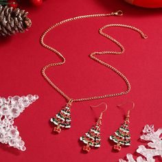 Decorate yourself in seasonal shine with this Christmas tree jewelry set complete with a necklace and earrings made from colorful enamel and 18k gold plating for holiday-ready accessorizing. Includes one pendant necklace and one pair of drop earrings Necklace: 15.75" L with 1.97" extender (chain); 0.71" W x 1.3" L (pendant) Earrings: 0.71" W x 1.89" L Lobster claw clasp 18k gold-plated copper / enamel Multicolor Jewelry Christmas Gift, Multicolor Christmas Jewelry Gift, Christmas Tree Jewelry, Christmas Tree Necklace, Tree Jewelry, Jewelry Christmas Tree, Tree Necklace, Holiday Ready, Jewelry Tree