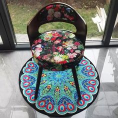 a chair that is sitting on top of a rug in front of a glass door