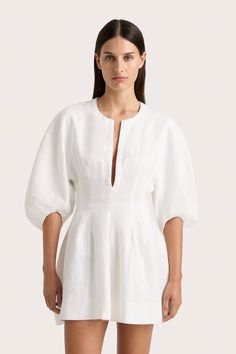 A vacation-style mini dress with a low split at the neckline and oversized rounded sleeves that reach down to the elbow. Imagined in White 100% European Flax® linen, it cinches in at the waist before falling into a soft A-line skirt with pleat details. A shorter iteration of the Soleil Maxi Dress, wear on warm summer days with simple accessories. Mini Dress White, Maxi Dress Sale, Mini Dresses Online, Swim Shirts, Faithfull The Brand, Spring Wardrobe, African Fashion Dresses, White Maxi Dresses, Summer Fits