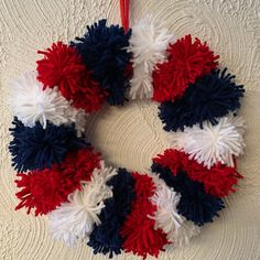 a red, white and blue wreath hanging on the wall