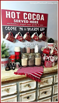 an old dresser with christmas stockings and hot cocoa on it