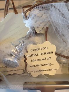 a basket filled with white and silver items on top of a table next to a sign