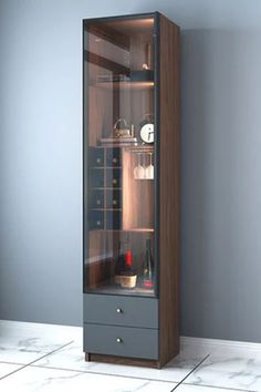 a tall glass cabinet in the corner of a room