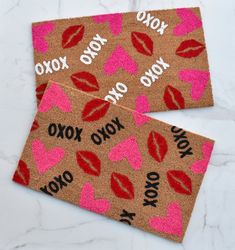 two valentine's day doormats with kisses on them, one says xoxo and the other says yoyo