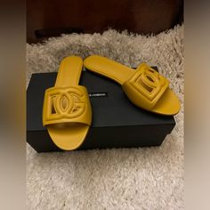 This Versatile Slide Sandal Is Topped With A Dimensional Dg Logo For Added Volume. Made In Italy Luxury Yellow Sandals For Summer, Designer Yellow Sandals For Beach, Designer Yellow Sandals For The Beach, Designer Yellow Leather Sandals, Luxury Yellow Open Toe Sandals, Elegant Yellow Sandals With Round Toe, Luxury Yellow Leather Sandals, Chic Flat Yellow Sandals, Chic Yellow Flat Sandals