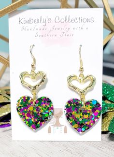 Purple, green and gold Mardi Gras heart dangle earrings. Made with glittervand resin. Lightweight,  hang about 2in. from ear. Ships free, will come gift wrapped. Green Heart Beads Earrings For Gift, Green Earrings With Heart Beads For Gifts, Handmade Green Earrings For Valentine's Day, Green Heart-shaped Earrings For Valentine's Day, Green Heart Drop Earrings For Gifts, Green Heart Earrings For Valentine's Day Party, Nickel-free Heart Drop Earrings For Party, Green Nickel-free Heart Earrings As Gift, Green Heart-shaped Jewelry For Party