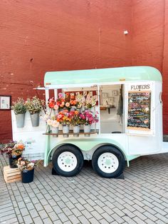 an ice cream truck with flowers on display