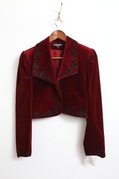 Elevate your style with this stunning Rare New J. Peterman velvet bolero jacket. The rich red color and intricate embroidered accents make it perfect for any occasion, from casual to formal. The long sleeves and collared neckline provide added warmth during the fall and winter seasons. This vintage piece is made with high-quality cotton velvet and lined with acetate for a comfortable fit. The short jacket length and solid pattern give it a classic, preppy vibe that is perfect for city or travel wear. Whether you're looking for a statement piece for a party or cocktail event, or simply want to add some designer flair to your workwear, this bolero jacket is sure to impress. Red And Gold Clothes, Drummer Oc, Jackets Aesthetic, Velvet Jacket Outfit, Velvet Jacket Women, Velvet Jackets Women, Velvet Bolero, Red Velvet Jacket, J Peterman