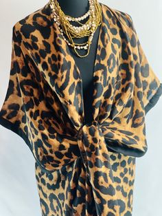 Introducing our Leopard Animal Print Summer Long Kimono Blouse, the epitome of chic and stylish summer attire. This kimono blouse is perfect for resort getaways, cruises, or beach vacations, offering a lightweight and breezy cover-up option that's both fashionable and functional. Featuring a striking leopard animal print design, this kimono adds a touch of wild elegance to any ensemble. Its long length and loose, flowing fit make it ideal for layering over swimwear or pairing with your favorite summer outfits. Crafted from lightweight fabric, this kimono is comfortable to wear in warm weather and offers a breathable layer of coverage. Whether you're lounging by the pool, strolling along the beach, or exploring a new destination, this kimono is the perfect choice for art lovers who apprecia Summer Silk Wrap Kaftan, Silk Wrap Kimono For Vacation, Silk Wrap Kaftan For The Beach, Chic Wrap Kimono Beach Cover-up, Chic Printed V-neck Kimono, Chic Wrap Kimono For Daywear, Chic V-neck Kimono For Daywear, Chic Oversized Wrap Kimono, Beachwear Kimono With Kimono Sleeves For Daywear