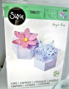 a package of paper flowers sitting on top of a table