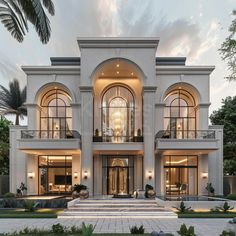 a large white house with lots of windows on the front and side of it, surrounded by palm trees