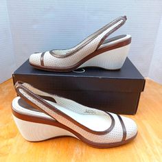 Beautiful Wedges In Ivory & Chocolate Brown By Cole Haan. With Elastic Slingback. Round Toe. Completely New With Original Box. Were Never Used. Size 7 B. Regular Wide. Height Wedges: 2 Inches 100% Leather Material Super Soft Air Cushioned Footbed Anti-Slip Rubber Sole. They Are Really Nice Wedges Shoes. Beige Synthetic Closed Toe Slingback Pumps, Cream Leather Slingback Pumps Medium Width, Cream Leather Slingback Pumps, White Synthetic Heels With Leather Sole, Classic Cream Slingback Pumps With Ankle Strap, Beige Leather Heels With Cushioned Footbed, Classic Cream Slingback Pumps For Spring, Beige Slingback Heels With Branded Insole, White Synthetic Closed Toe Slingback Pumps