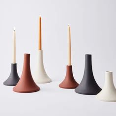 four candles are lined up in different colors