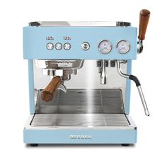 a blue espresso machine sitting on top of a white counter next to a wooden handle