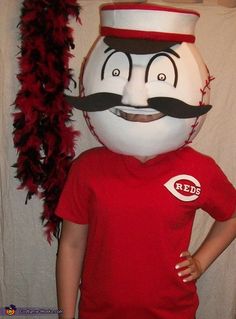 a young boy standing in front of a large white ball with a mustache