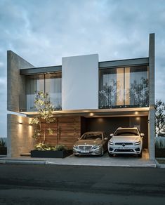 two cars parked in front of a modern house