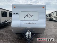 an rv parked in a lot with other trailers