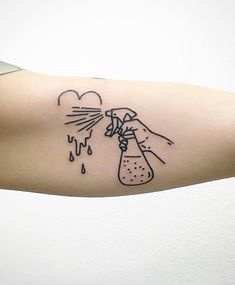 a person's arm with a tattoo on it that has an image of a flask