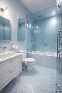 a bathroom with blue and white tiles on the walls