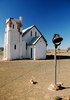 an old church sits in the middle of a deserted desert area with no people around it