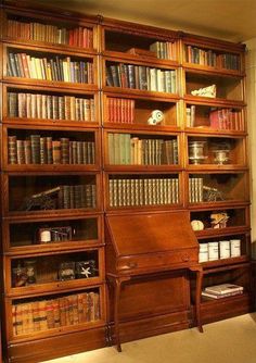 an old wooden bookcase with many books on it and some shelves full of books