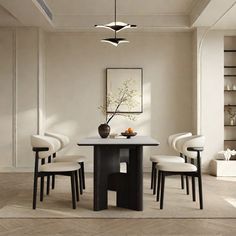 a dining room table with four chairs around it