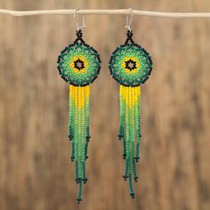 Elaborated with verdant hues of green and yellow a majestic pair of waterfall earrings is handcrafted with petite glass beads. Learning from her parents and grandparents Mexican artisan Adriana Trejo designs this inspiring accessory. Each earring dangles from a hook of sterling silver. Green Chandelier Earrings With Colorful Beads, Traditional Green Teardrop Beaded Earrings, Unique Green Beaded Dangling Earrings, Green Beaded Dangle Chandelier Earrings, Green Teardrop Beaded Earrings With Dangling Beads, Unique Green Teardrop Beaded Earrings, Unique Green Beaded Earrings, Unique Green Earrings With Colorful Beads, Handmade Green Dangle Chandelier Earrings