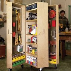 a man standing in front of a workbench filled with tools