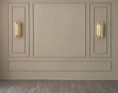 an empty room with white walls and gold handles on the doors is pictured in this image