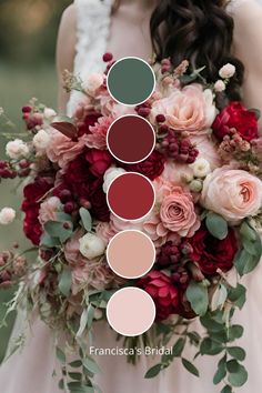 a bridal bouquet with roses and greenery in shades of red, pink, green