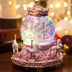 a merry go round toy with horses and lights on it's top, sitting on a table