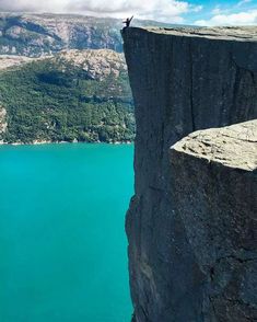 a person standing on the edge of a cliff