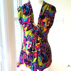 This Beautiful Colorful Printed Top Looks Like The 60's As Far As The Style Of Fabric. In The Middle The Fabric Is Brought Together With A Metal Gold Snake With Red Eyes. The Is The Slightest Cap Sleeve. The Top Measures Pit To Pit 19". Waist 16.5", And Length Of Top Is 25". Washing Instructions Are Hand Wash Gently. The Fabric Is 95% Polyester And 5% Spandex. Just A Gorgeous Blouse! It's Like Brand New! Multicolor Fitted Retro Tank Top, Fitted V-neck Blouse In Multicolor Print, Fitted V-neck Blouse With Vibrant Print, Multicolor Print Sleeveless Top For Beach, Multicolor Sleeveless Beach Top, Sleeveless Multicolor Print Tops For Beach, Purple V-neck Tank Top For Party, Chic Multicolor Floral Print Tank Top, Sleeveless Top With Vibrant Print