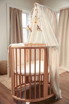 a baby's crib in a room with curtains