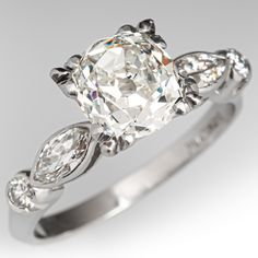 a diamond engagement ring with three pear shaped diamonds