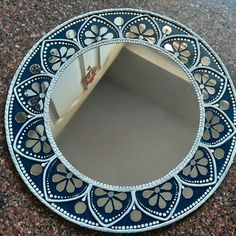 a blue and white mirror sitting on top of a counter