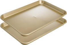 two gold trays sitting side by side on top of each other in front of a white background