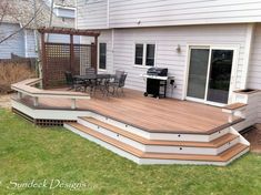 a deck with steps and grill in the back yard