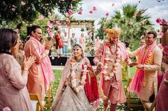 a bride and groom walking down the aisle