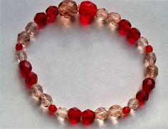 Stretch bracelet faceted glass beads.  Red coloured and clear glass Women, girls bracelet. Fits small to medium size wrist. Bracelet size 7.5 inches. Red Faceted Beaded Bracelets For Gifts, Red Faceted Round Bead Bracelets, Red Faceted Round Bracelets, Adjustable Red Czech Glass Bracelets, Adjustable Red Czech Glass Bracelet, Red Glass Beaded Bracelets With Round Beads, Red Glass Beaded Bracelets, Red Czech Glass Bracelet With Round Beads, Adjustable Red Glass Bracelets