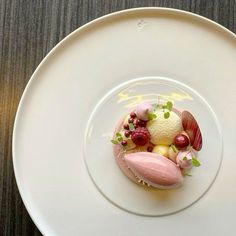 a white plate topped with food on top of a wooden table