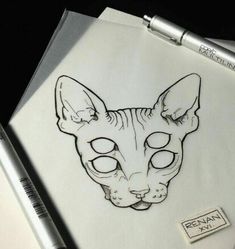 a drawing of a sphydrah cat with eyes drawn on paper next to a pen