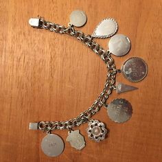 "This vintage sterling silver charm bracelet is from the 60's. It has 9 sterling silver charms including a small round disc with a cougar, Niagara Falls enameled ,expo 67 Montreal Canada, disc with engraved\"Shelly\" 12_19_65, Happy Birthday from Barbara 3-4-66, mustard seed, Debate N. F. L. 1969, Sr. High Chorus 1969. The bracelet is 7.5\" long on a double link chain with a very secure lock. This probably is a bracelet from Canada judging from the engraving. A very unique collection of charms . Vintage Sterling Silver Dangle Charms, Sterling Silver Vintage Dangle Charms, Collectible Sterling Silver Jewelry With Vintage Charm, Sterling Silver Jewelry With Vintage Charm For Collectors, Sterling Silver Jewelry With Vintage Charm, Nickel-free Antique Silver Sterling Silver Charm Bracelet, Vintage Medallion Charms, Silver Sterling Vintage Charm Bracelet, Vintage Sterling Silver Charm Bracelet As Gift