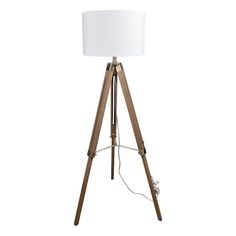 a wooden tripod floor lamp with a white shade on the top and an electric plugged in